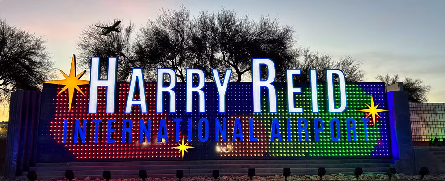 Harry Reid International Airport sign at dusk.