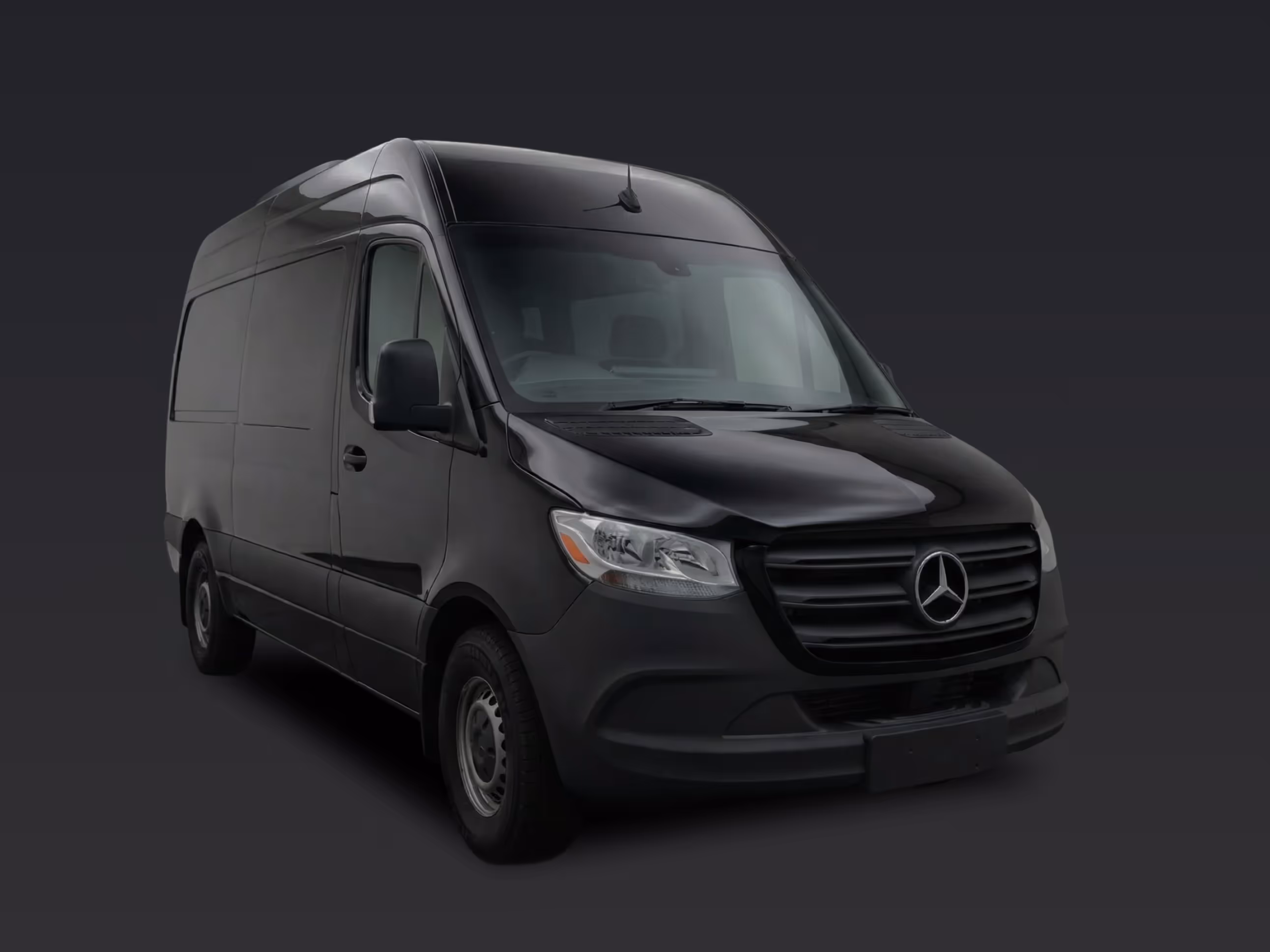 Side view of a black Mercedes Sprinter Van for group travel.
