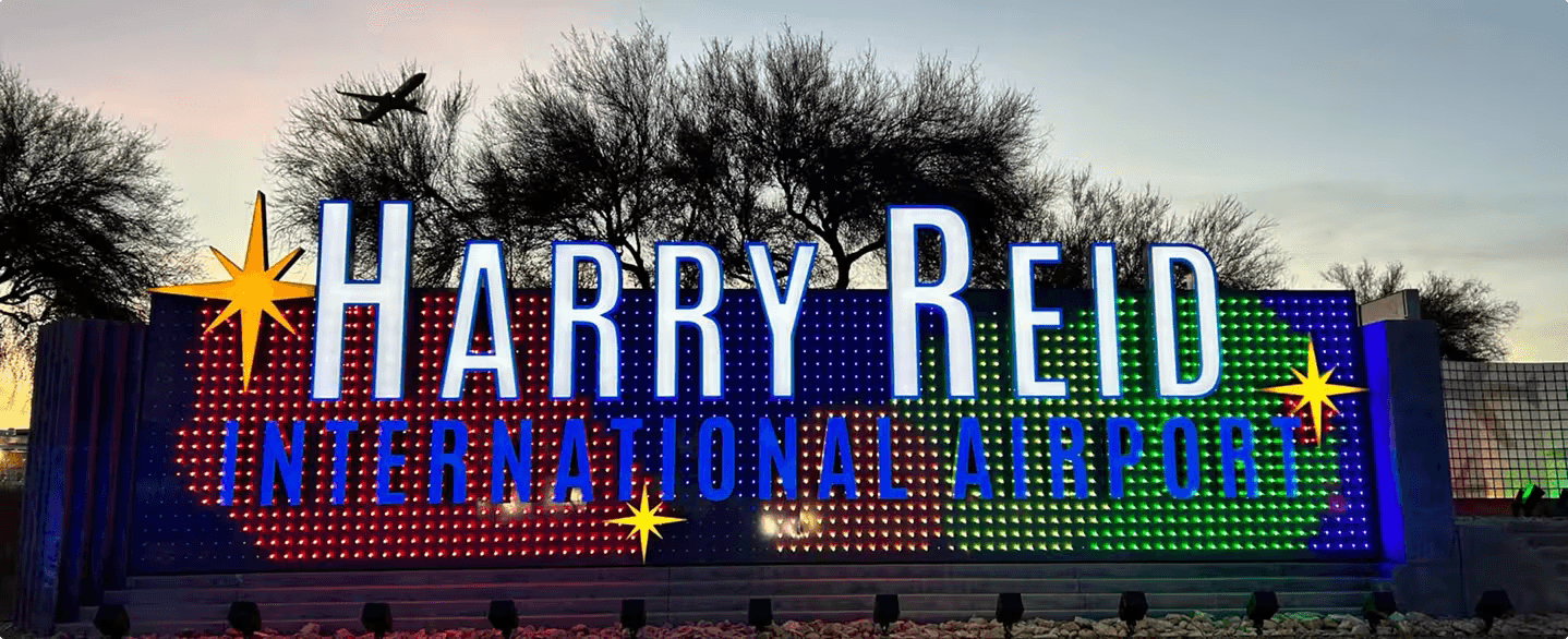 Harry Reid International Airport sign at dusk.