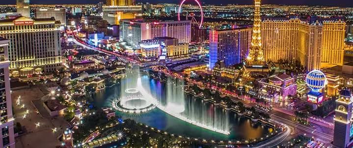 Panoramic aerial view of the Las Vegas Strip resorts and Bellagio fountains illuminated at night