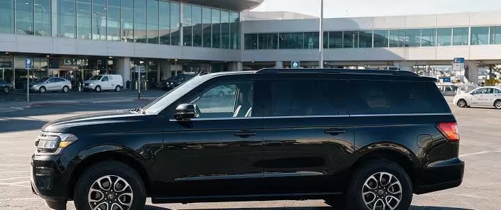 Black executive SUV parked at the Harry Reid International Airport pickup zone